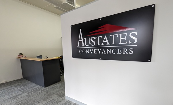 Austates Conveyancers front of the office with banner